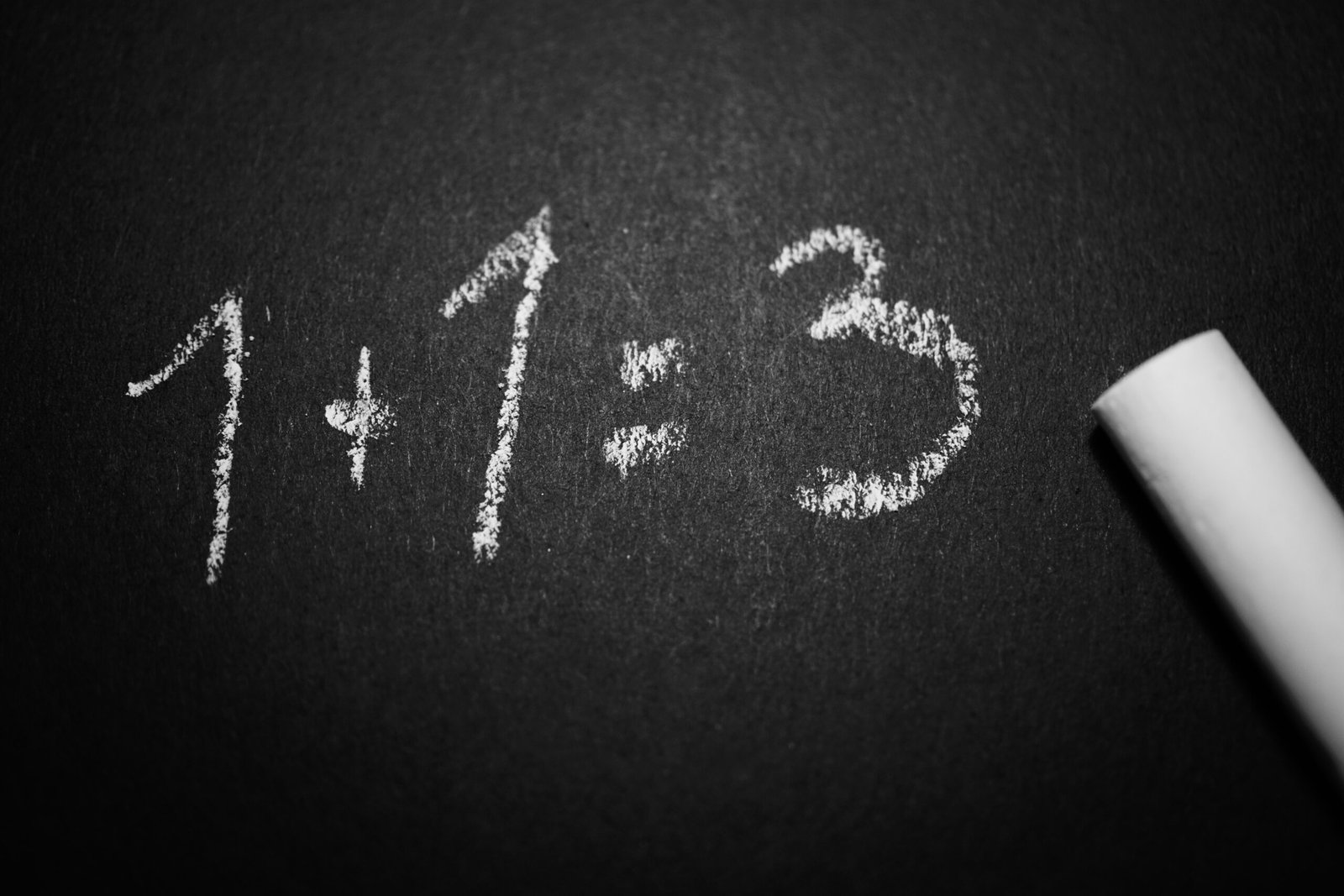 The incorrect equation “1 + 1 = 3” written in chalk on a blackboard.