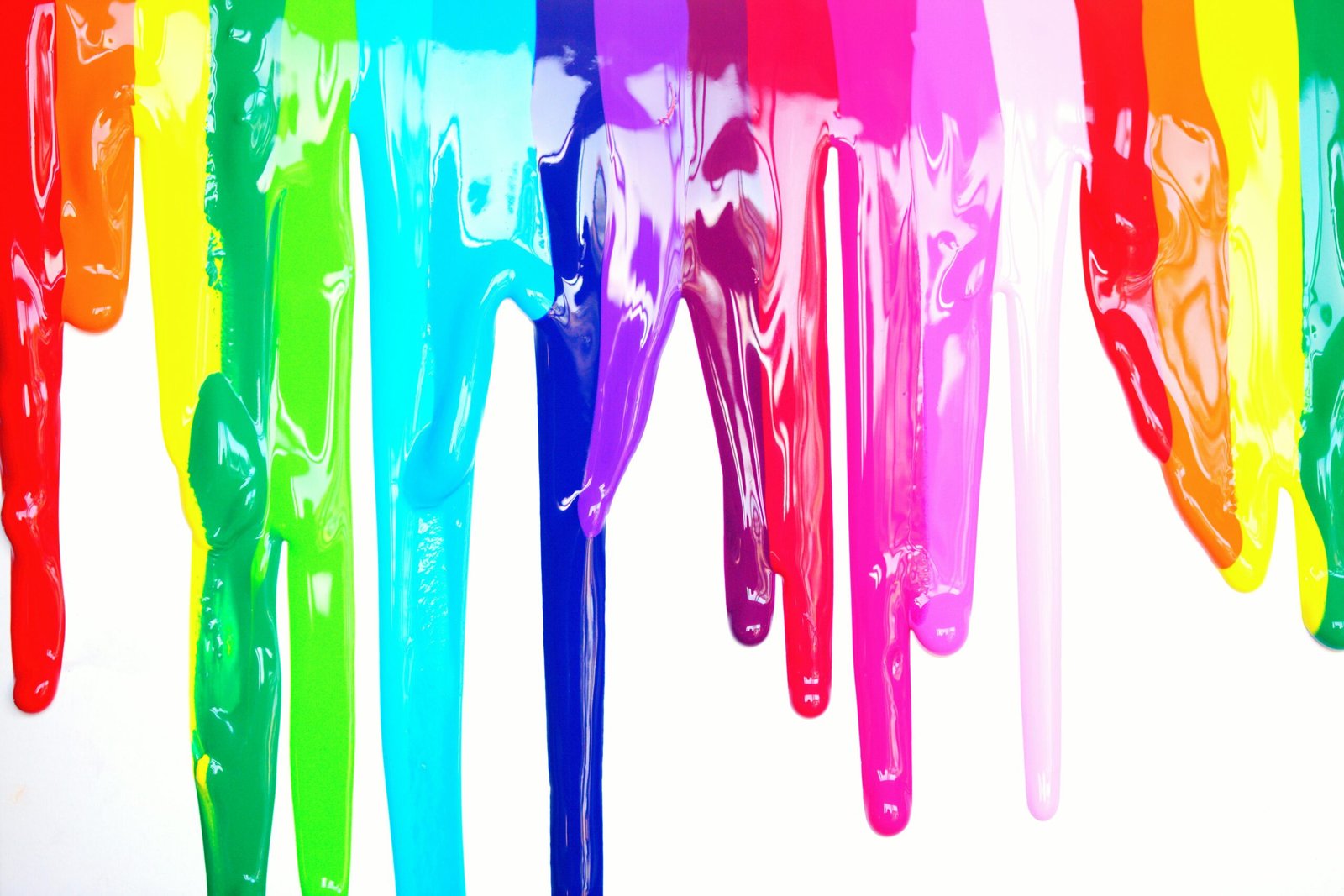 Rainbow-colored paint dripping against a white background.